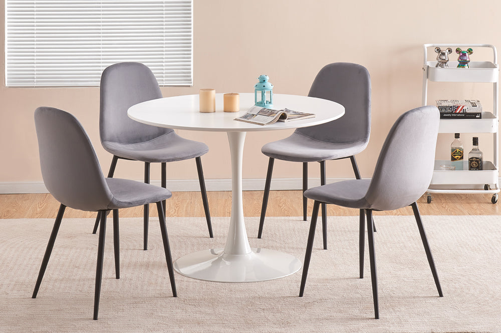 White round dining table with grey velvet chairs